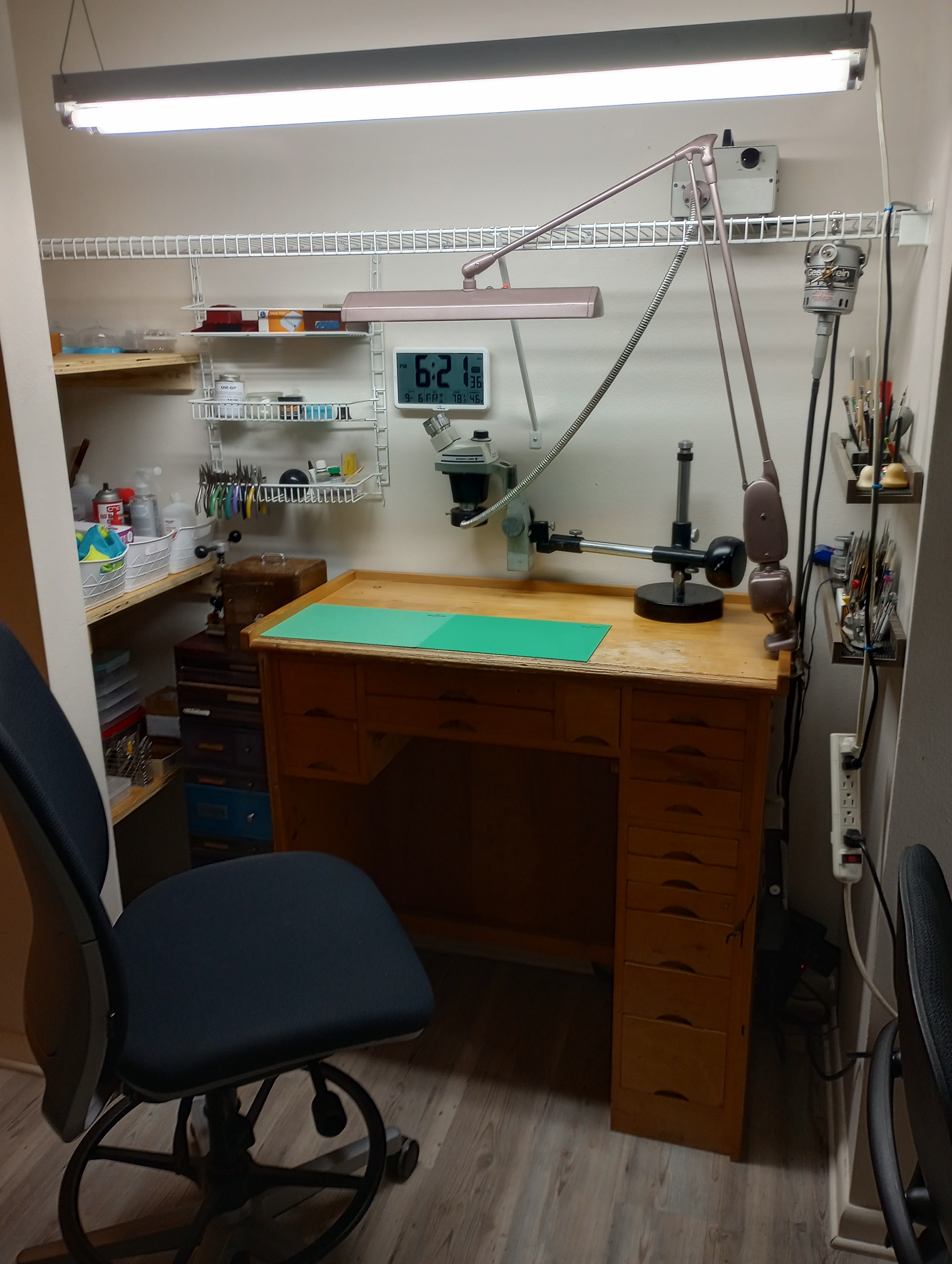Watchmaker at workbench with precision tools
