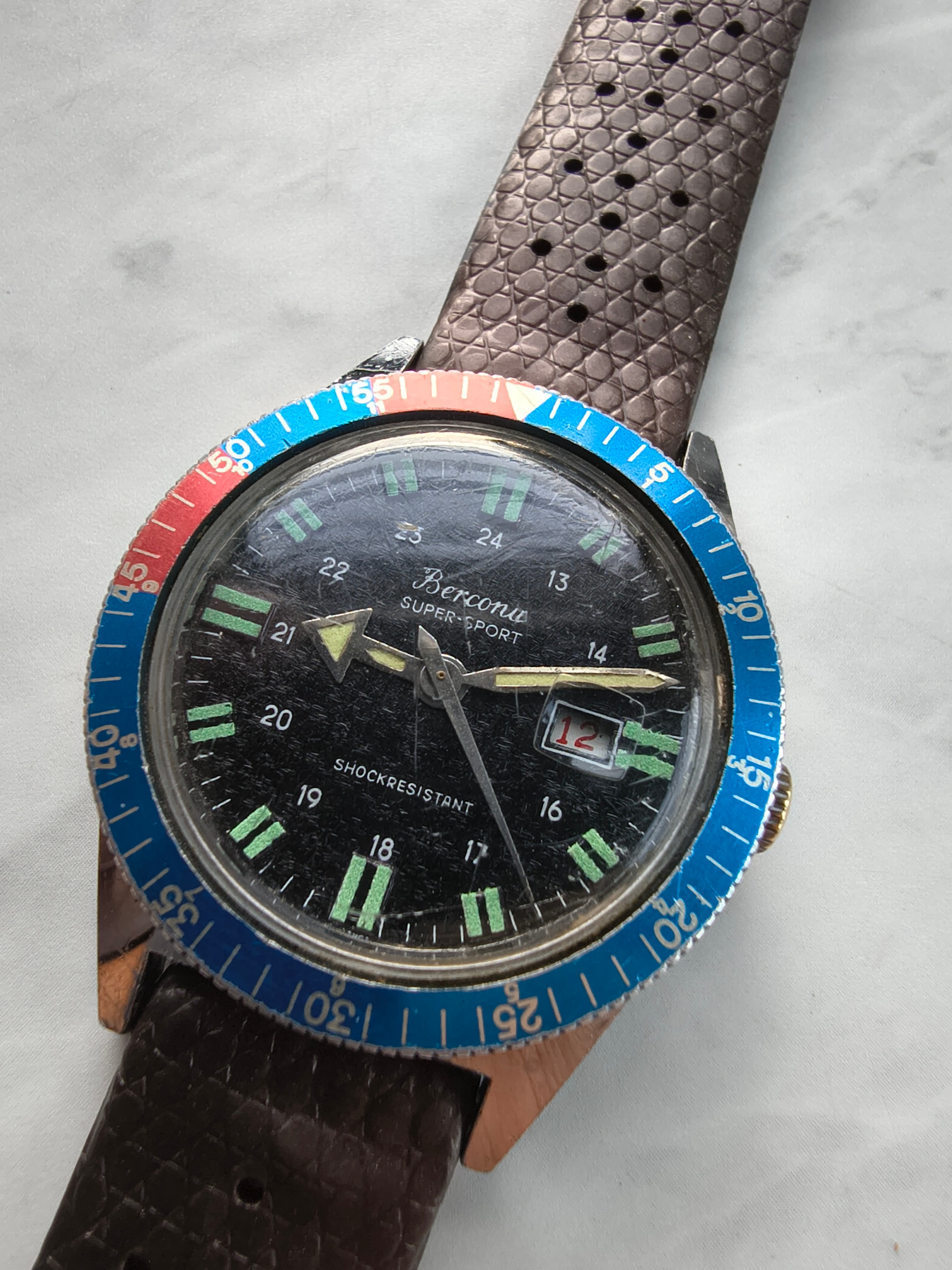 Luxury watch on wooden surface flat lay